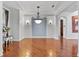 Bright dining room featuring hardwood floors, stylish lighting, decorative columns, and neutral wall paint at 19238 Climbing Aster Dr, Tampa, FL 33647