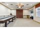 Spacious game room with recessed lighting, shuffleboard table, and built-in shelving at 19238 Climbing Aster Dr, Tampa, FL 33647