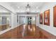 Elegant living room boasting hardwood floors, decorative columns, stylish lighting, and ample space for entertaining at 19238 Climbing Aster Dr, Tampa, FL 33647