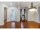 Formal Living Room featuring hardwood floors, elegant lighting fixture and view to entry at 19238 Climbing Aster Dr, Tampa, FL 33647