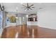 Spacious living room with hardwood floors, large windows, and an open layout connected to the kitchen area at 19238 Climbing Aster Dr, Tampa, FL 33647
