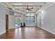 Bright living room featuring a tray ceiling, tile floors, large windows, and access to the backyard pool area at 19238 Climbing Aster Dr, Tampa, FL 33647