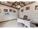 Home office features wooden ceiling beams, desk and chair, and boxing themed wall decor at 19238 Climbing Aster Dr, Tampa, FL 33647