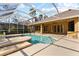 Enjoy the Florida weather in this home's screened-in private pool with lush landscaping at 19238 Climbing Aster Dr, Tampa, FL 33647