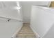 Staircase with carpeted steps, white walls, and handrail at 19238 Climbing Aster Dr, Tampa, FL 33647