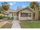 Charming single-story home featuring a screened-in porch and a well-manicured front yard with lush landscaping at 2120 4Th N Ave, St Petersburg, FL 33713