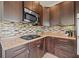 Well-maintained kitchen featuring dark cabinetry, stainless steel microwave, and tile backsplash at 2120 4Th N Ave, St Petersburg, FL 33713