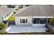 Aerial view of the home's backyard, featuring a stone patio and enclosed porch at 2166 Andrews Ct, Dunedin, FL 34698