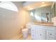 Bright bathroom featuring a white vanity with granite countertops and tile flooring at 2166 Andrews Ct, Dunedin, FL 34698