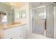 Bathroom featuring granite countertops, white cabinets, a shower, and tile flooring at 2166 Andrews Ct, Dunedin, FL 34698