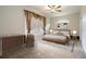 Comfortable bedroom featuring a ceiling fan, carpeted floors, and neutral-colored walls with natural light at 2166 Andrews Ct, Dunedin, FL 34698