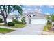 Charming single-story home featuring a two-car garage, well-manicured landscaping, and inviting curb appeal at 2166 Andrews Ct, Dunedin, FL 34698