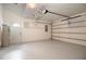 A clean garage with a ceiling fan, water heater, and an automatic door opener at 2166 Andrews Ct, Dunedin, FL 34698
