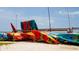 Colorful kayaks stacked on the sandy beach in this vibrant waterfront community at 2166 Andrews Ct, Dunedin, FL 34698