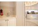 Functional laundry room with a sink, ample cabinet space, and view into kitchen at 2166 Andrews Ct, Dunedin, FL 34698