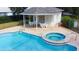 Well-maintained community pool and jacuzzi area with a covered seating space and neat landscaping at 2166 Andrews Ct, Dunedin, FL 34698