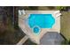 Aerial view of the in-ground pool with lounge chairs, a hot tub and a pool house at 2166 Andrews Ct, Dunedin, FL 34698