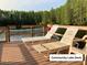 Community lake deck with lounge chairs overlooking the lake and forest at 2210 Vista Del Sol Cir # 519, Lutz, FL 33558
