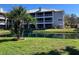 Beautiful condo complex with metal roof, screened balconies, and lovely water feature with fountains and palm trees at 2210 Vista Del Sol Cir # 519, Lutz, FL 33558