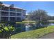 Condo complex with screened balconies overlooking a beautiful pond with fountains and well-maintained landscaping at 2210 Vista Del Sol Cir # 519, Lutz, FL 33558