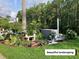 Beautiful landscaping with a sitting bench, outdoor shower, and a hot tub at 2210 Vista Del Sol Cir # 519, Lutz, FL 33558