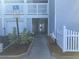 Exterior walkway with garage and stairs, featuring well maintained access and parking at 2210 Vista Del Sol Cir # 519, Lutz, FL 33558