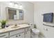 Bathroom with updated vanity, framed mirror, and new toilet with wrapped seat at 2301 Grenoble Pl # 1, Sun City Center, FL 33573