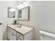 Neutral bathroom with vanity, marble countertop, and toilet in clean, bright space at 2301 Grenoble Pl # 1, Sun City Center, FL 33573