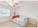 Bright bedroom with neutral tile floor, ceiling fan, and ample natural light for a relaxing atmosphere at 2301 Grenoble Pl # 1, Sun City Center, FL 33573