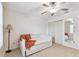 Bright bedroom featuring neutral walls, tile flooring, a ceiling fan, and closet at 2301 Grenoble Pl # 1, Sun City Center, FL 33573