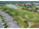An aerial view of the golf course, a lake, and the community's residential area at 2301 Grenoble Pl # 1, Sun City Center, FL 33573