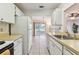 Bright kitchen showcasing functional layout and access to a relaxing outdoor living area at 2301 Grenoble Pl # 1, Sun City Center, FL 33573
