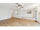 Open-concept living area featuring laminate floors and a glimpse of the kitchen at 2301 Grenoble Pl # 1, Sun City Center, FL 33573