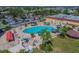Aerial view of a large community pool surrounded by lounge chairs and lush trees at 2301 Grenoble Pl # 1, Sun City Center, FL 33573