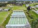 Aerial view of shuffleboard courts with lawn bowling and tennis in the background at a Florida community at 2301 Grenoble Pl # 1, Sun City Center, FL 33573