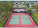 Aerial view of tennis courts with green nets and red surfaces at a Florida community at 2301 Grenoble Pl # 1, Sun City Center, FL 33573