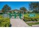 Community dog park with separate areas for small and large dogs, green fencing, and rules posted at 2458 Columbia Dr # 4, Clearwater, FL 33763