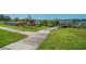 Kayaks for residents line the shore of the lake with a small walking bridge at 2458 Columbia Dr # 4, Clearwater, FL 33763