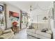 Cozy living room featuring tile floors, comfortable seating, and natural light from large windows at 2458 Columbia Dr # 4, Clearwater, FL 33763