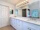 Large bright bathroom featuring double sinks, a large mirror, and a tiled floor at 3014 Starmount Dr, Valrico, FL 33596