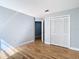 This bedroom features wood flooring, gray walls, a closet, and a doorway at 3014 Starmount Dr, Valrico, FL 33596