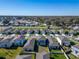 Aerial view of a residential neighborhood with well-manicured lawns and sidewalks at 3204 Fresno Pl, Zephyrhills, FL 33541