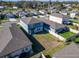 Aerial shot of a fenced backyard highlighting community living with manicured lawns and contemporary home designs at 3204 Fresno Pl, Zephyrhills, FL 33541