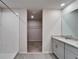 Bathroom view to the shower and walk-in closet, with a double vanity at 3204 Fresno Pl, Zephyrhills, FL 33541