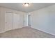 A well-lit bedroom features neutral carpeting and a closet with double doors at 3204 Fresno Pl, Zephyrhills, FL 33541