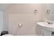 Charming half bathroom featuring pedestal sink and modern fixtures at 3204 Fresno Pl, Zephyrhills, FL 33541