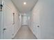 Open hallway featuring neutral walls, wood-look flooring and access to other rooms at 3204 Fresno Pl, Zephyrhills, FL 33541