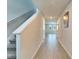 Bright hallway featuring durable wood-look flooring and staircase access to the upper levels at 3204 Fresno Pl, Zephyrhills, FL 33541