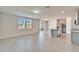 Bright living room offering wood-look flooring, natural light and a view of the kitchen island at 3204 Fresno Pl, Zephyrhills, FL 33541