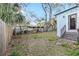 Spacious backyard with a wooden fence and a mix of grass and natural ground cover at 3307 S Manhattan Ave, Tampa, FL 33629